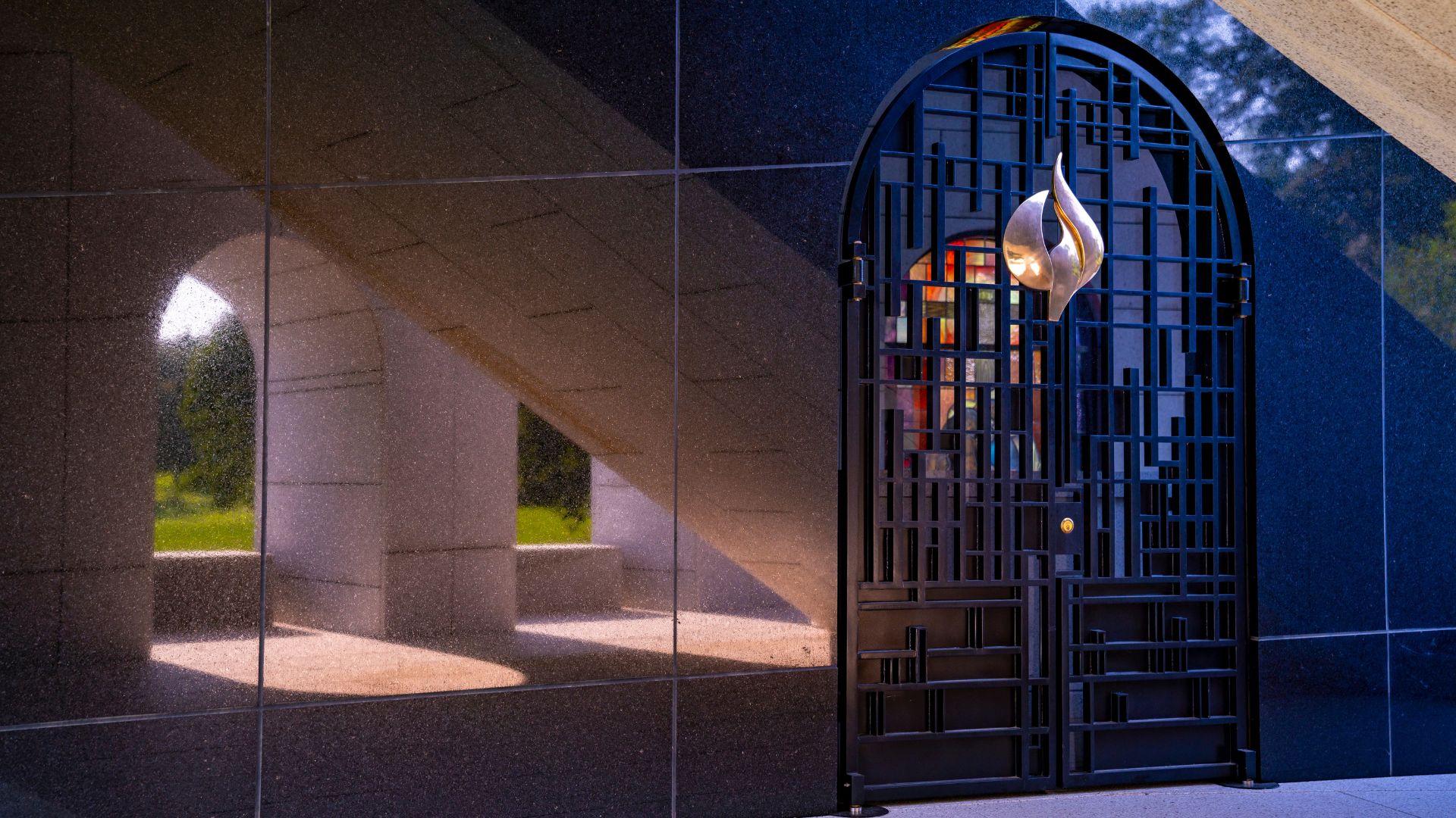 A massive, modern mausoleum features mirrored sides.