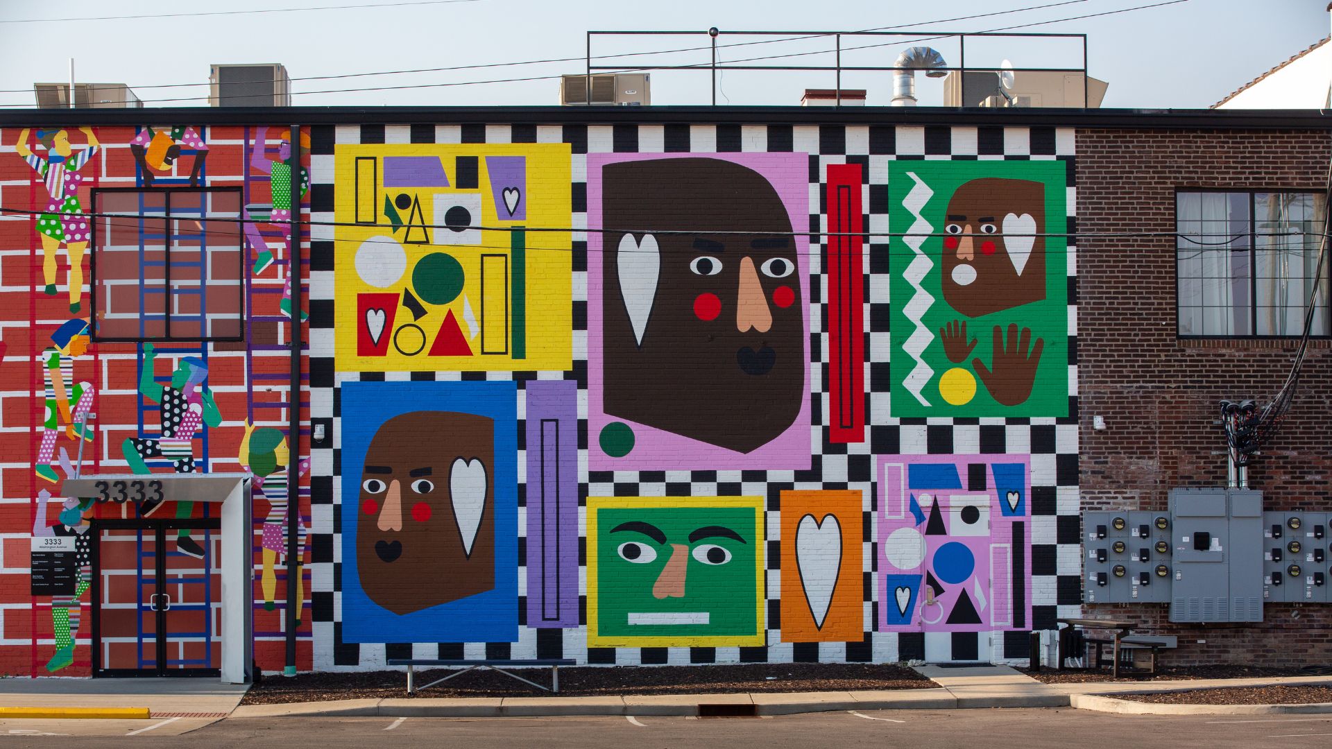 Part of The Walls Off Washington, this mural features a variety of faces on colorful backgrounds.