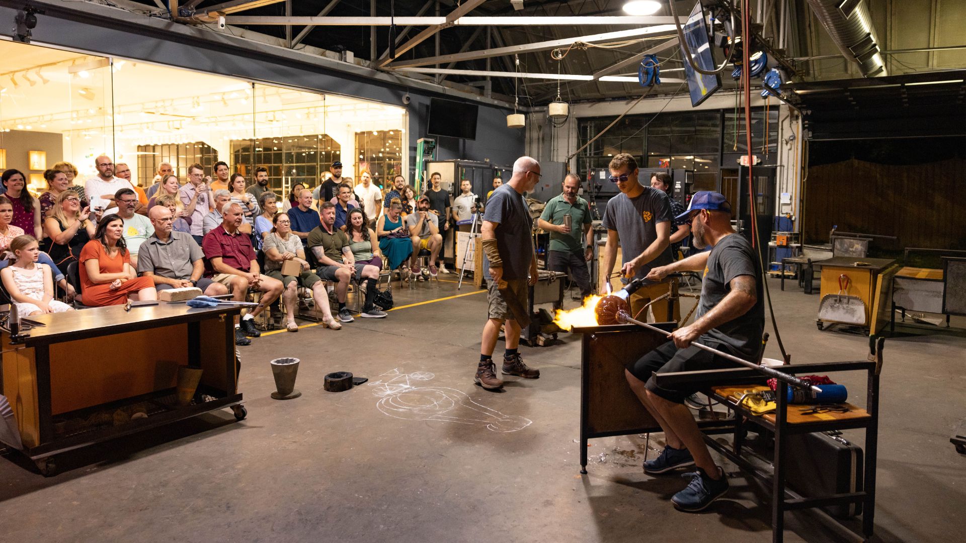 Guests watch a glass-blowing demonstration at Third Degree Glass Factory.