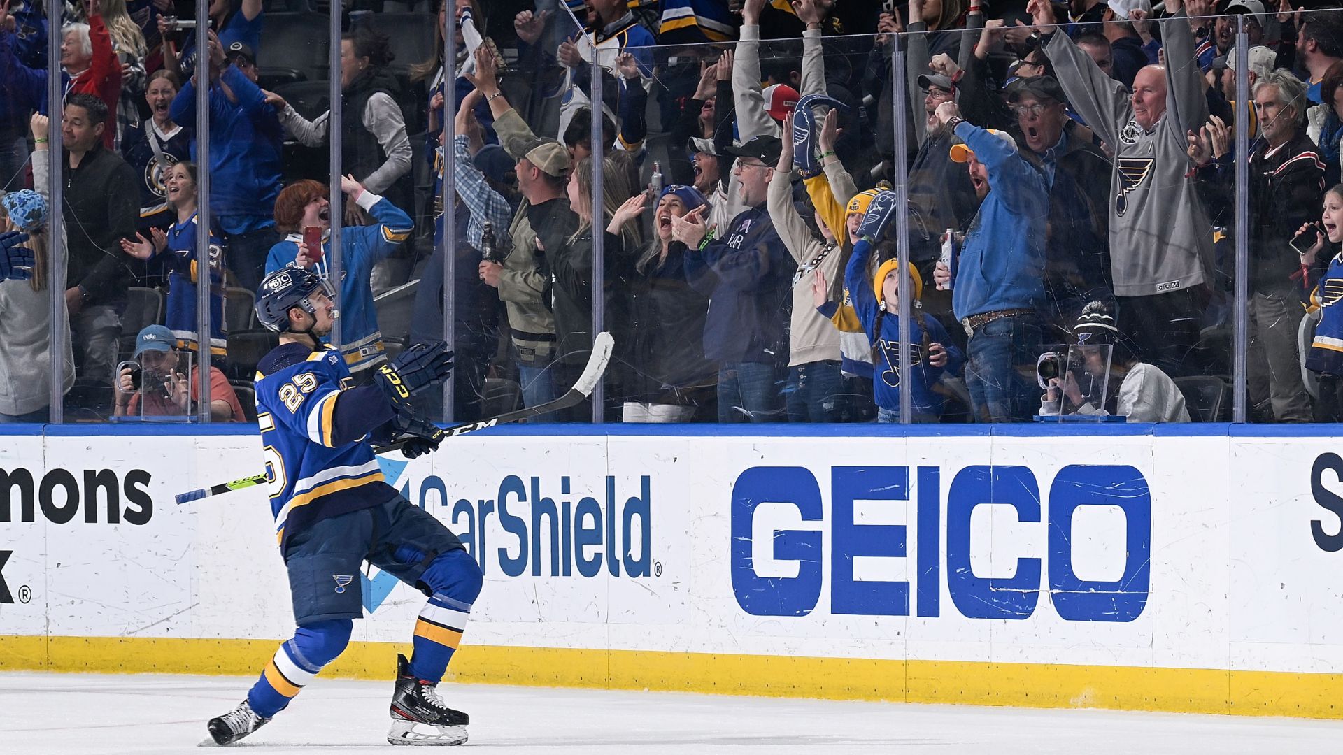 Jordan Kyrou throws a puck into the stands at a St. Louis Blues home game.