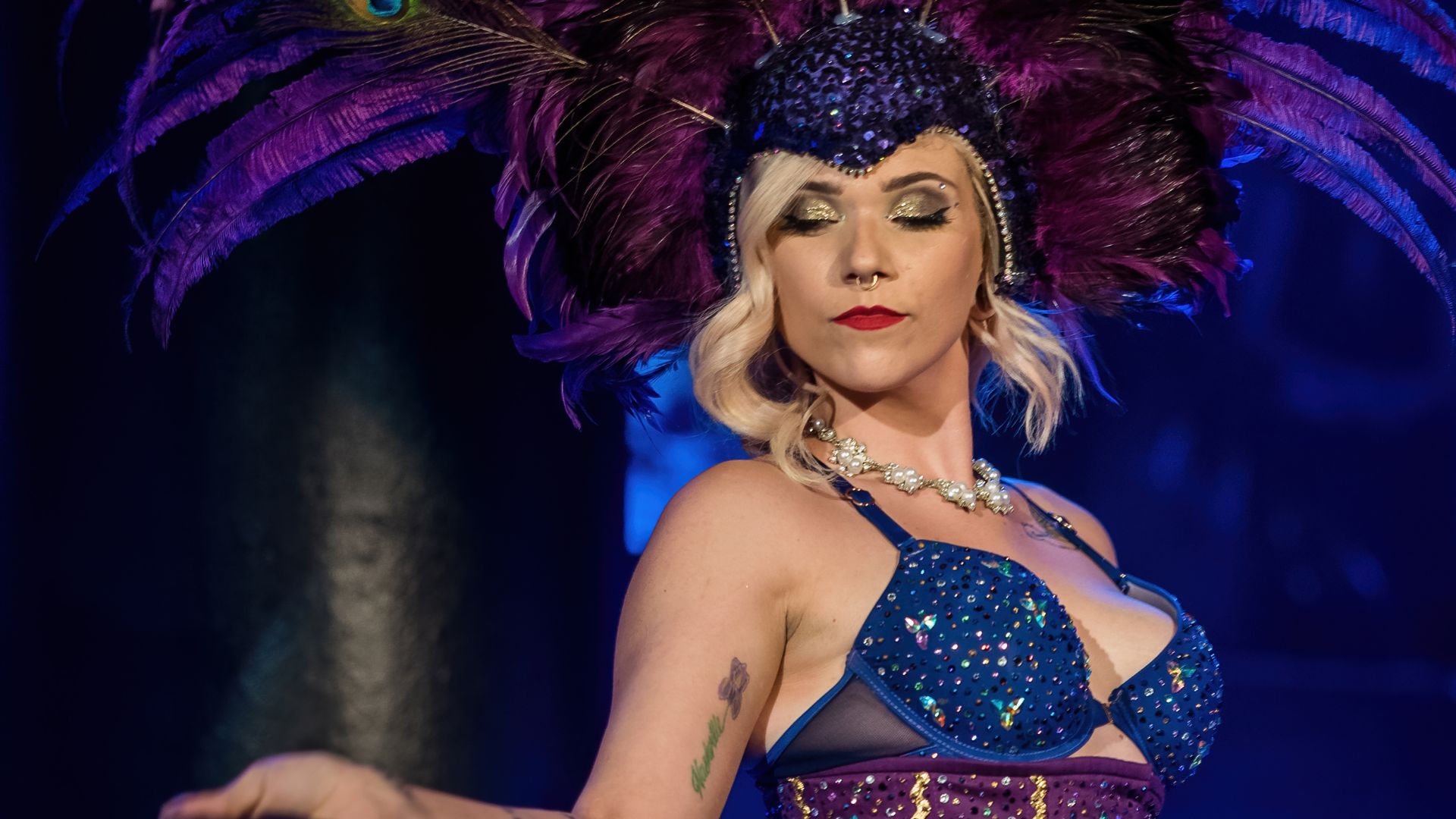 A woman in a purple feather headdress performs at The Boom Boom Room.