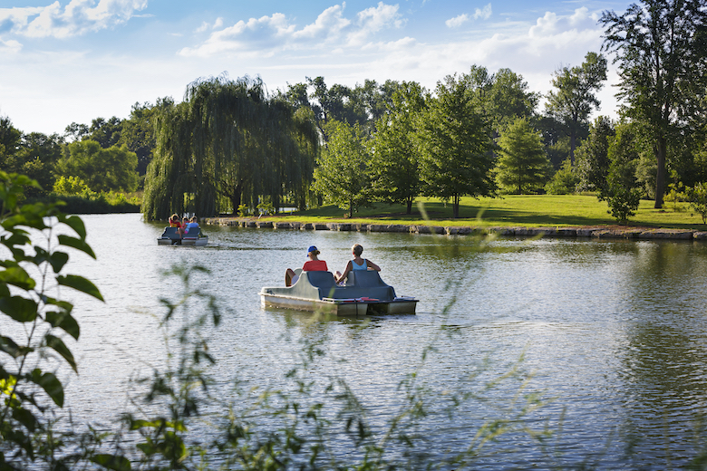 Visitors enjoy a paddle boat ride in Forest Park.