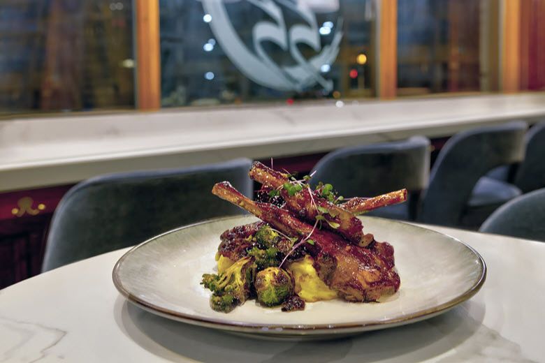 Prime 55 serves sweet glazed lamb chops with garlic mashed potatoes and a seasonal vegetable medley in two locations in St. Louis.