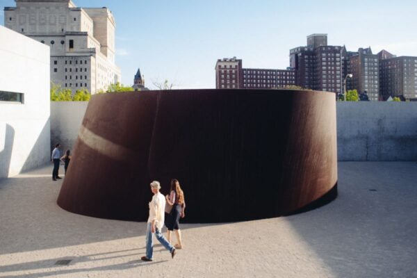 Visitors walk around a sculpture of weathering steel set into a torqued spiral at the Pulitzer Arts Foundation.