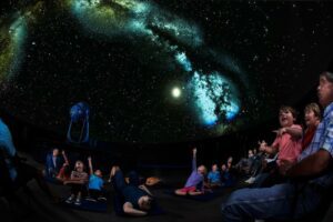 Families explore the night sky at the Saint Louis Science Center.