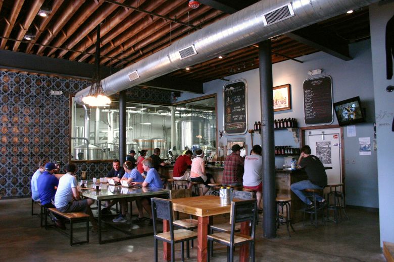 People mill about the taproom at 4 Hands Brewing Co. in downtown St. Louis.