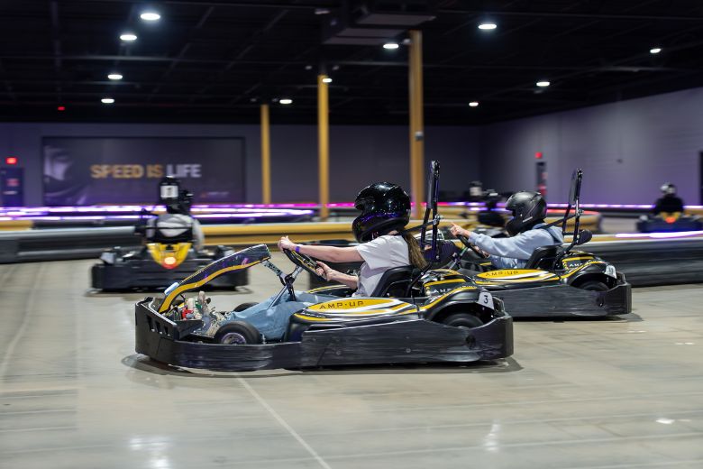 Teenagers drive go-karts at Amp Up Action Park in St Louis.