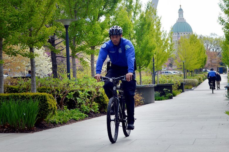 A police officer rides his bike along Market Street in downtown St. Louis