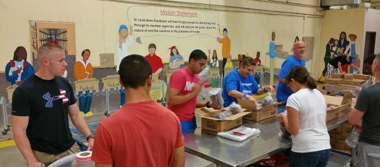 Volunteers package food for distribution at the St. Louis Area Foodbank.