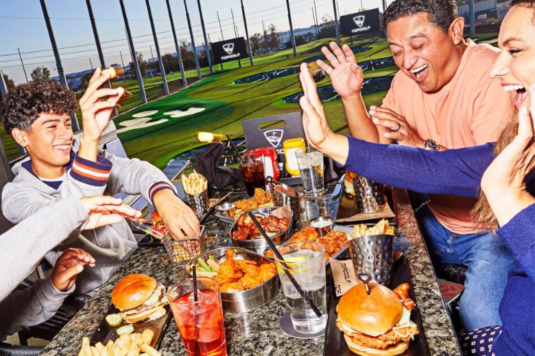 Traveling teens enjoy tech-infused golf and elevated bar food at Topgolf in Chesterfield.