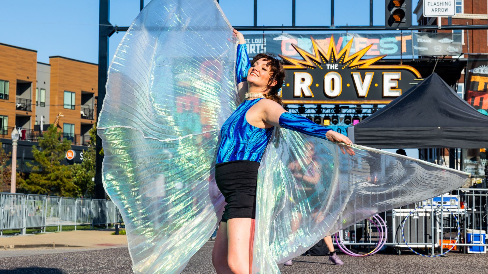 A woman with wings dances at Grovefest in St Louis.