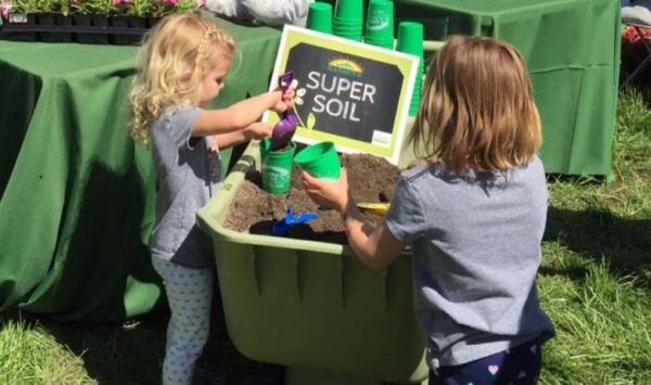 Kids play with soil at the St. Louis Earth Day Festival.