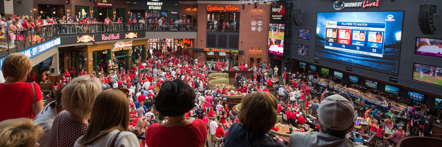 Cardinals fans watch the game on the gigantic screen at Ballpark Village.