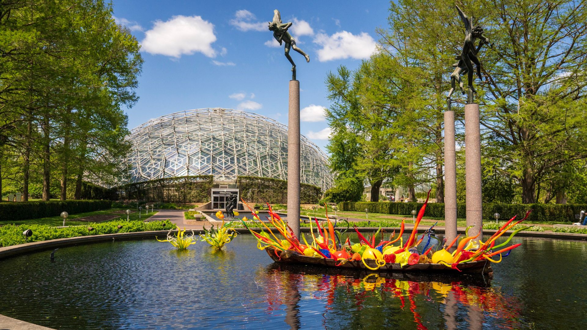 A boat of organic glass shapes sits in front of the Climatron at the Missouri Botanical Garden during Chihuly in the Garden 2023.