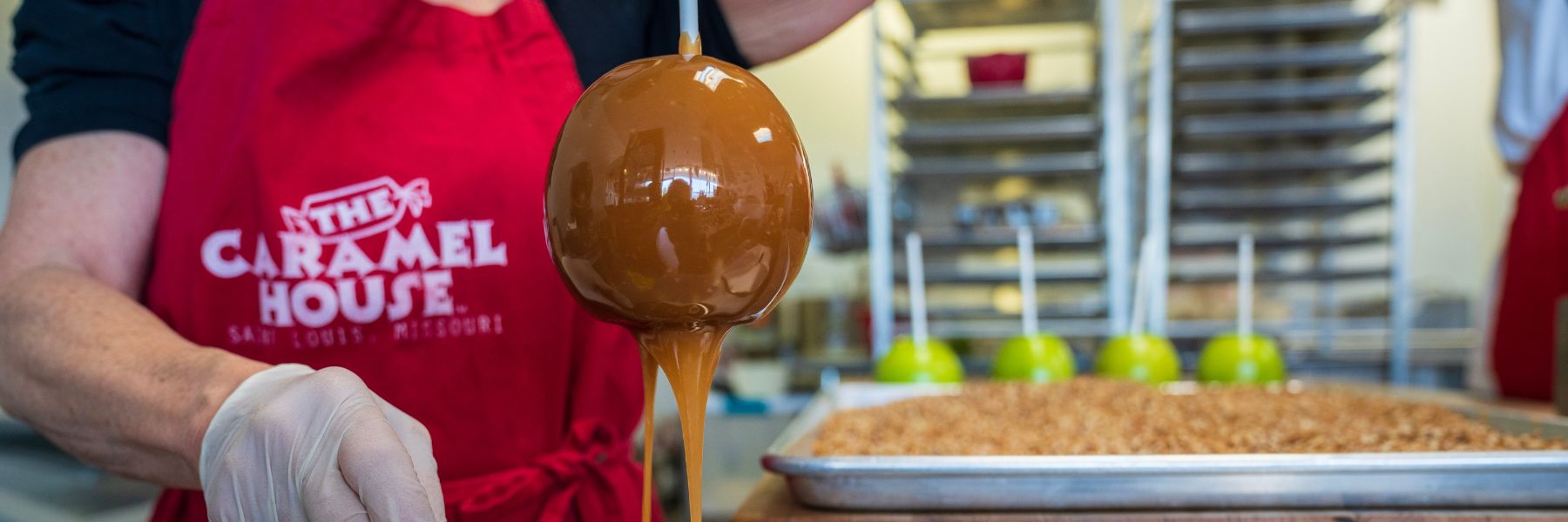 Janet Shulman hand-dips caramel apples at The Caramel House in St. Louis.