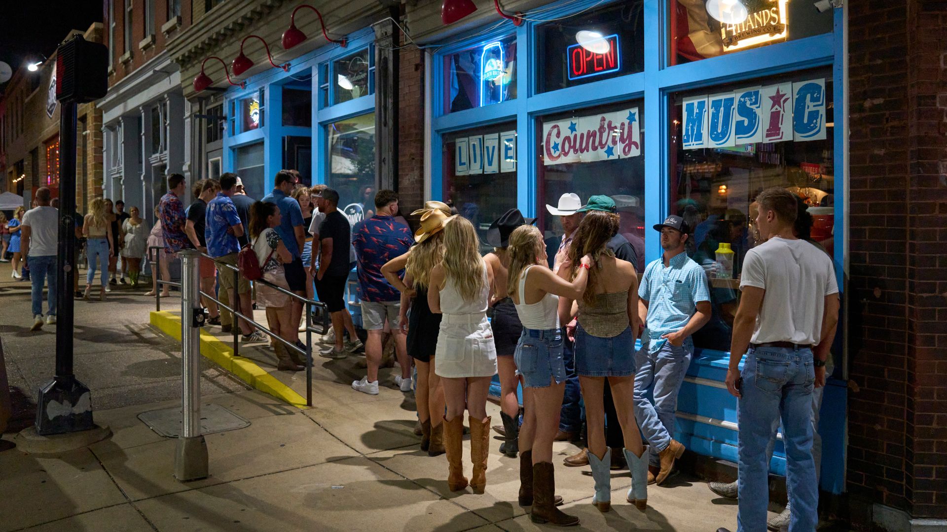 People line up to enter The Honky Tonk in downtown St. Louis.