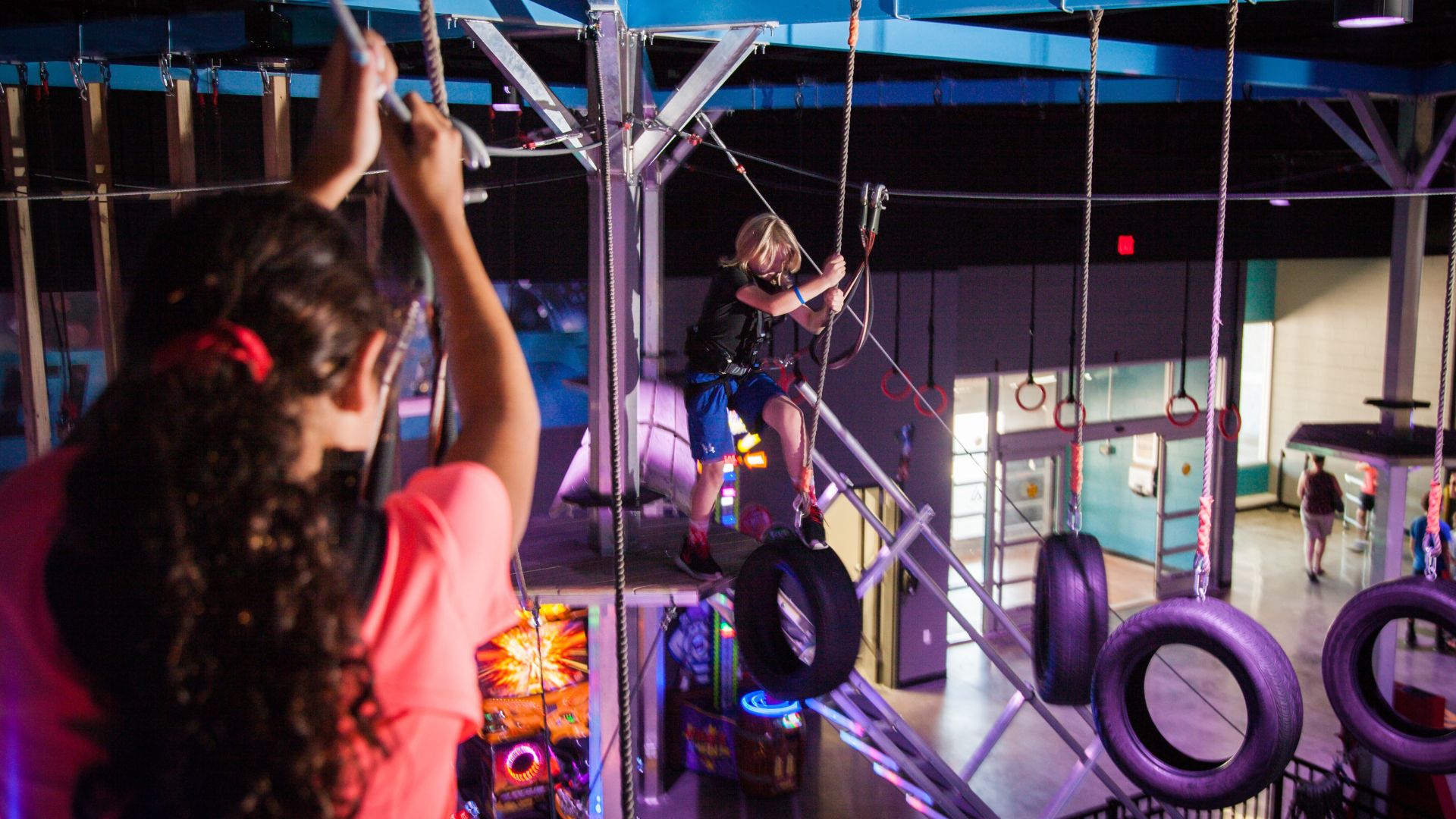 Kids traverse a high ropes course at Amp Up Action Park.