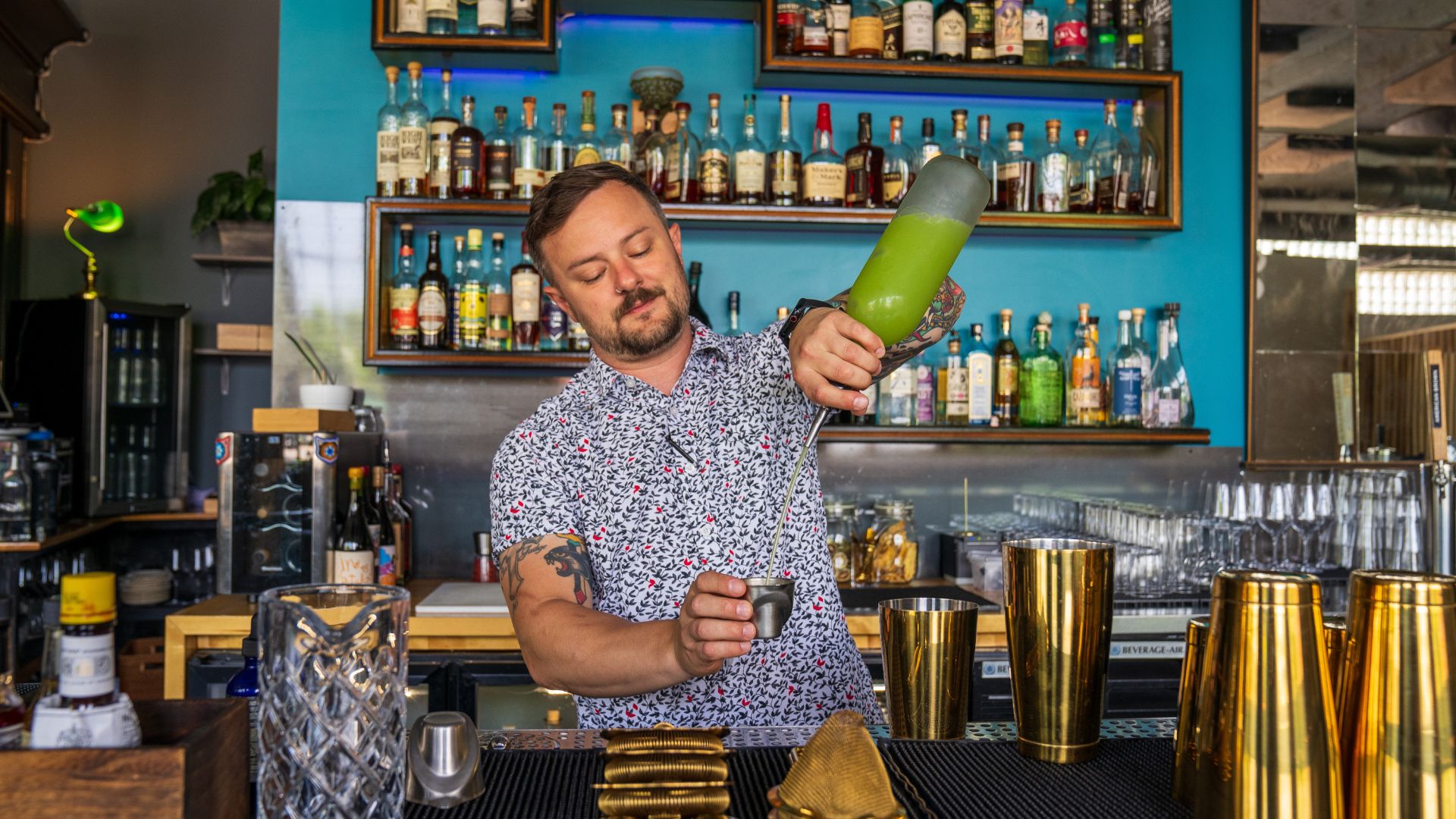 Corey Moszer mixes drinks behind the bar at The Lucky Accomplice.