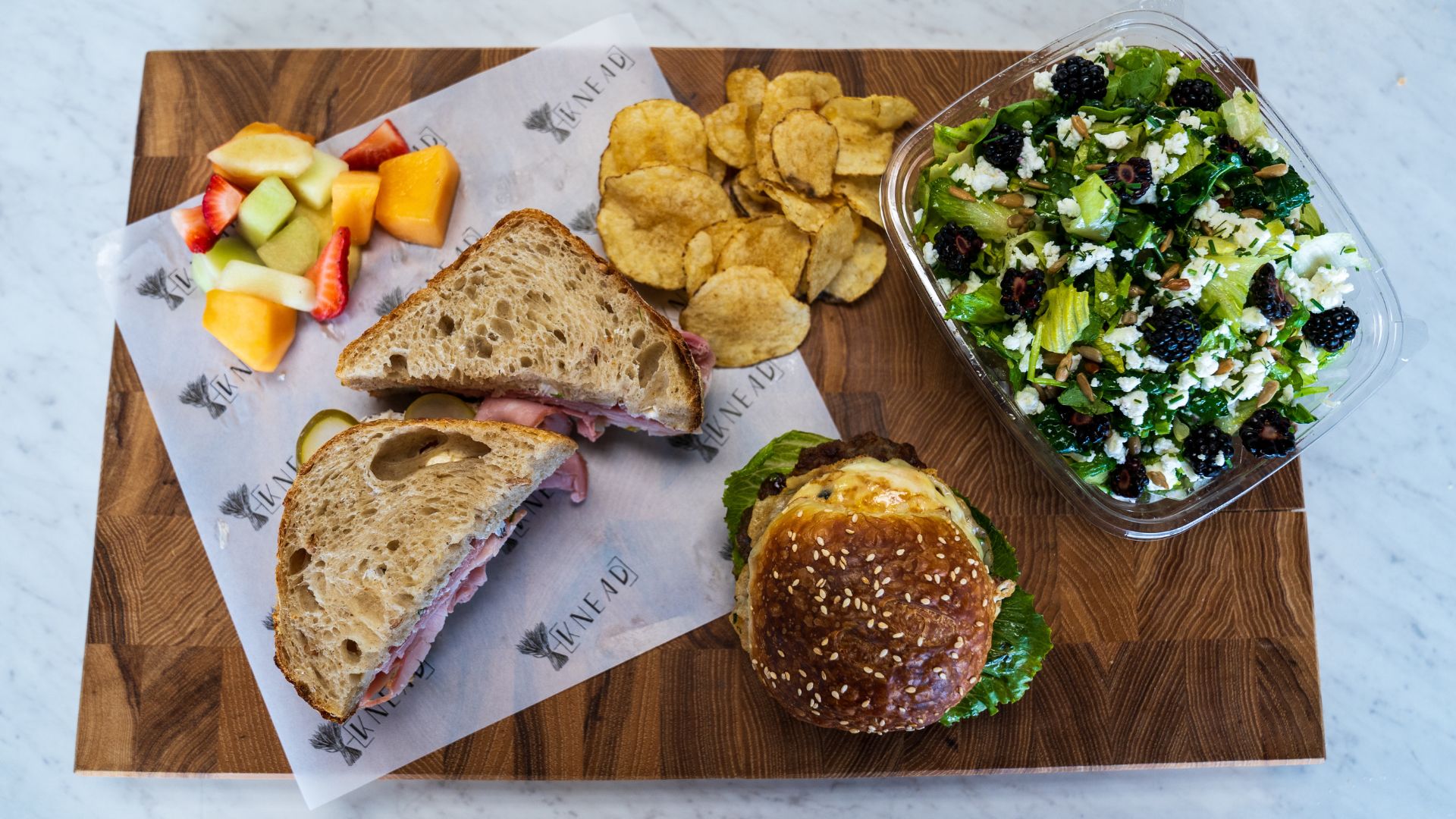 Knead Bakehouse + Provisions serves sandwiches on sourdough alongside salads, chips and fruit.