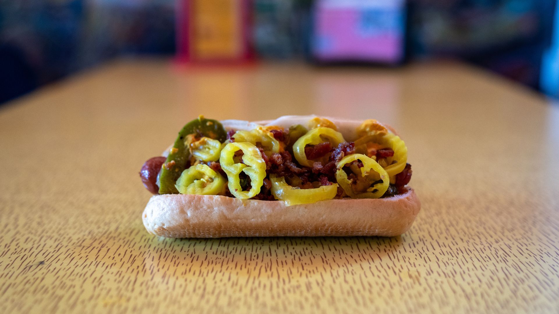 The St. Louis Dog features a fresh bun lined with Provolone and an all-beef hot dog topped with grilled onions, grilled bell peppers, banana peppers, bacon and smoked pepper mustard.