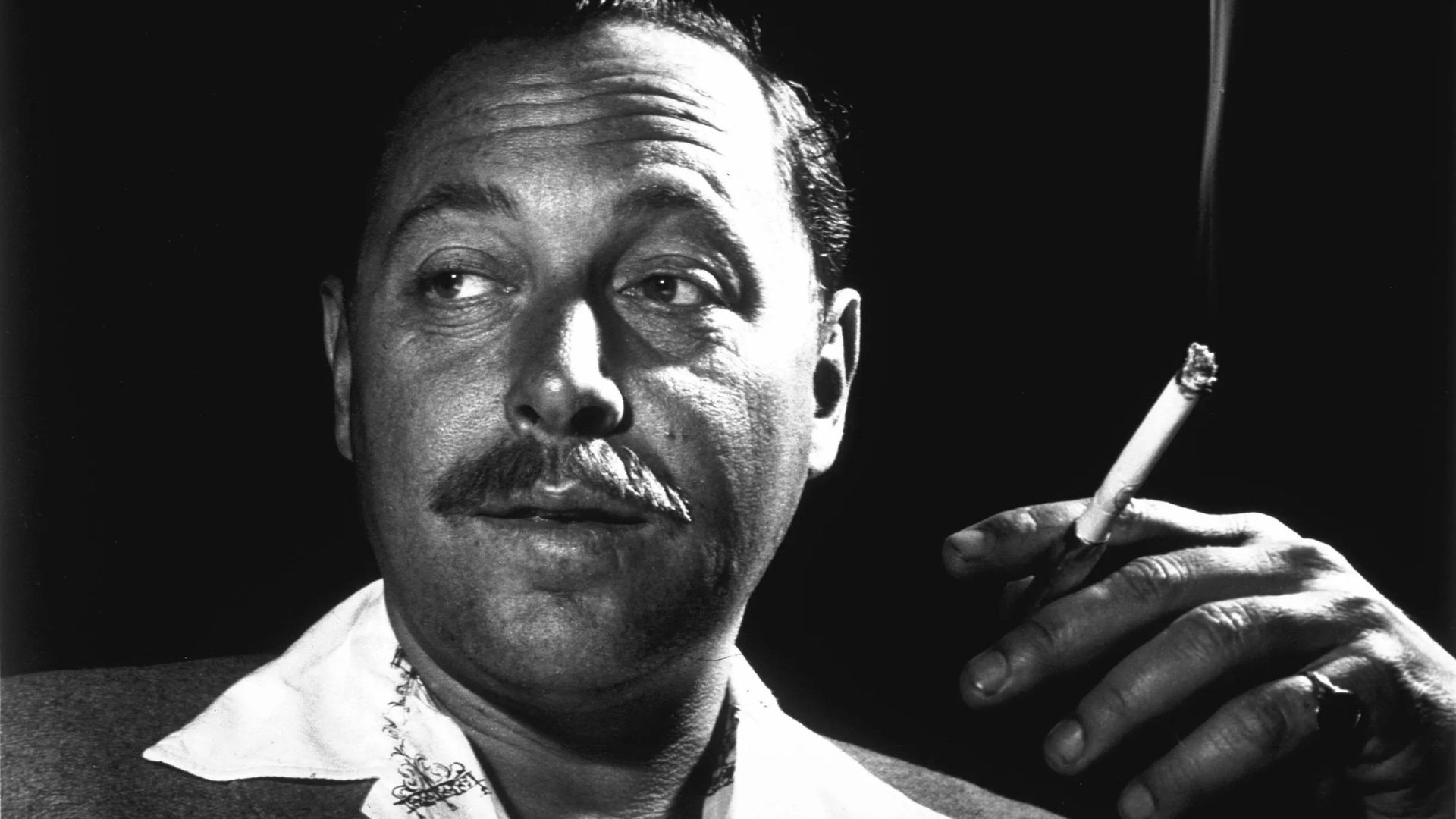 Tennessee Williams smoking a cigarette.