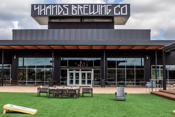 4 Hands at The District features a courtyard where you can play cornhole, watch sports games and listen to live music.