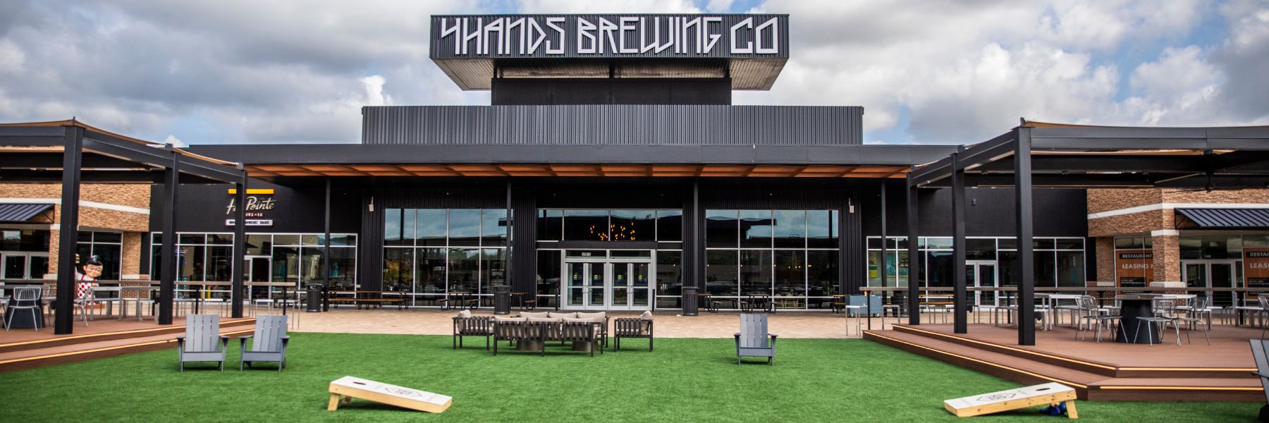 4 Hands at The District features a courtyard where you can play cornhole, watch sports games and listen to live music.