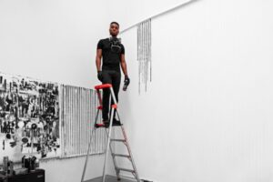 Adam Pendleton poses as he sets up his solo exhibition at the Mildred Lane Kemper Art Museum.