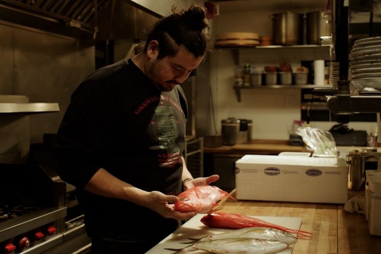 Nick Bognar prepares fish at his restaurant Indo.