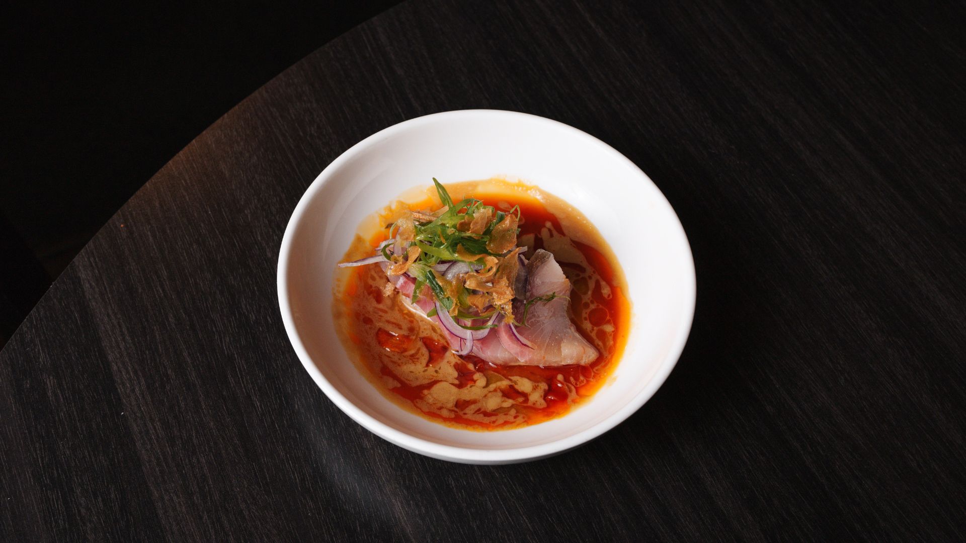 At Indo, chef Nick Bognar pairs fatty yellowtail with coconut nam pla (fish sauce), Thai kosho (a play on traditional yuzu kosho), candied garlic and housemade chile oil.