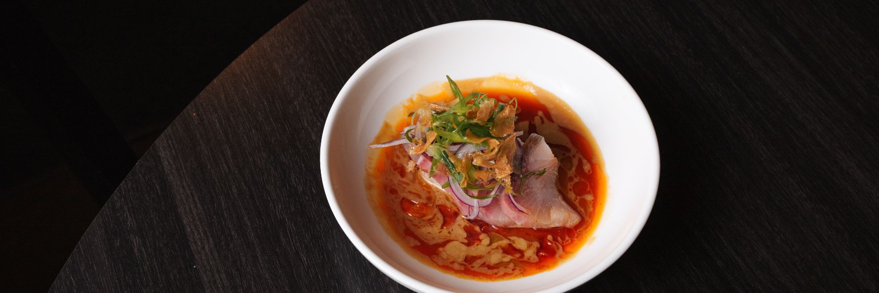 At Indo, chef Nick Bognar pairs fatty yellowtail with coconut nam pla (fish sauce), Thai kosho (a play on traditional yuzu kosho), candied garlic and housemade chile oil.