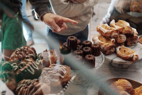 Guests choose decadent pastries from the pastry case at La Pâtisserie Chouquette.