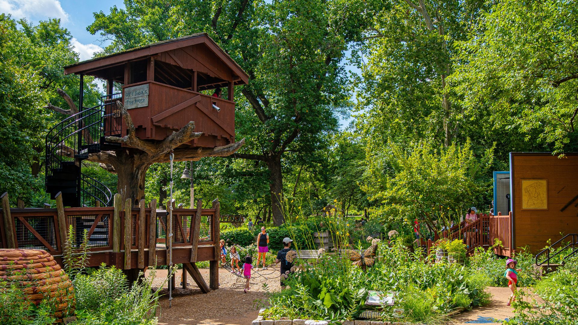 Families play in the outdoor children's garden at the Missouri Botanical Garden.