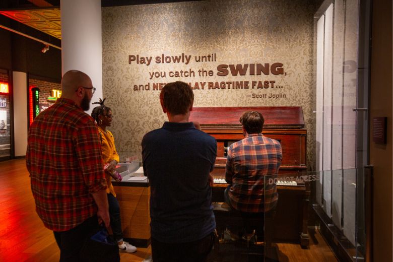 Visitors play a piano at the National Blues Museum.