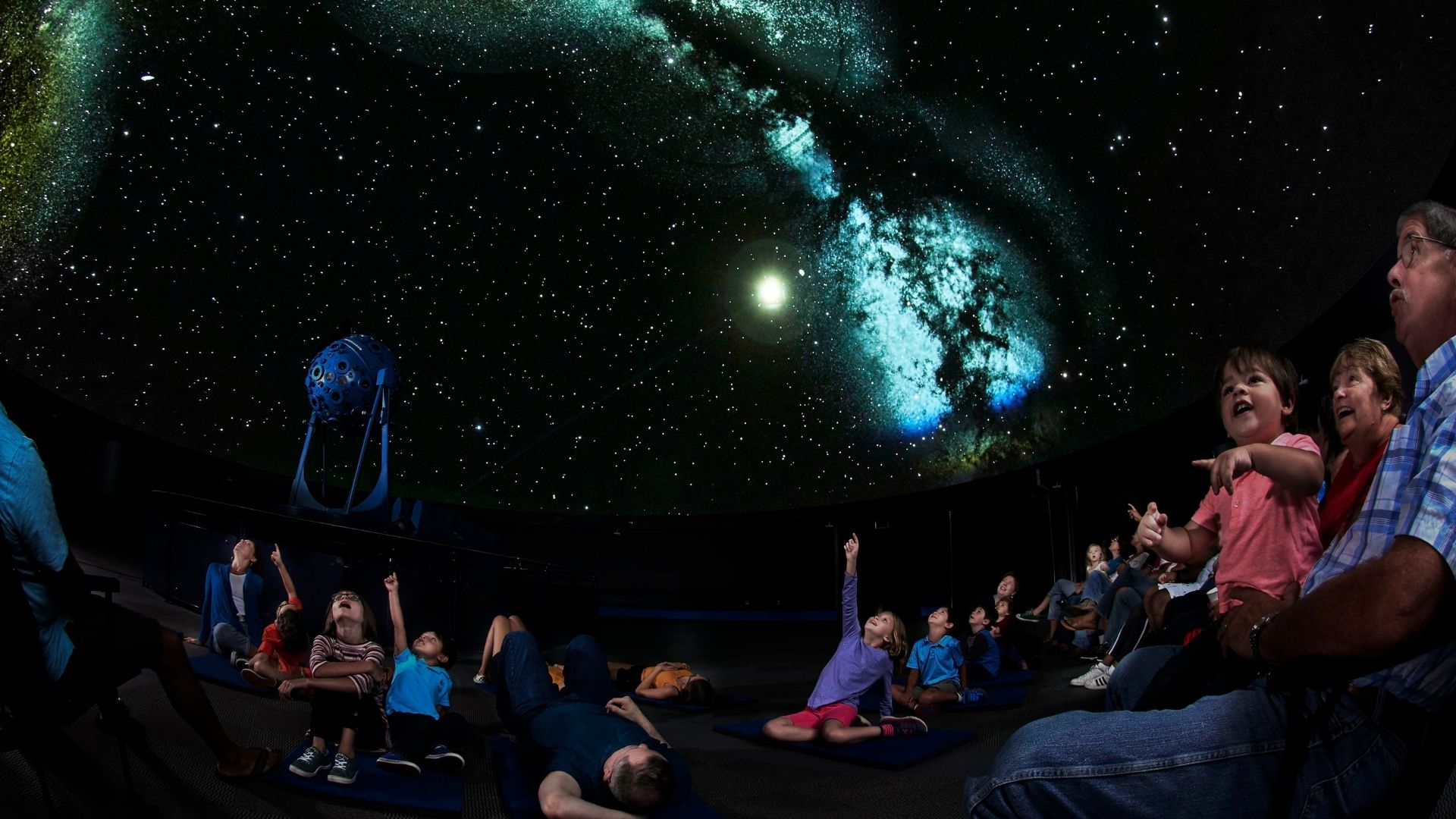 People of all ages marvel at the night sky at the Saint Louis Science Center, where STEAM activities abound.