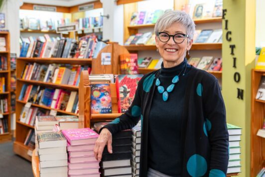 Kris Kleindienst poses in her legendary bookstore, Left Bank Books.