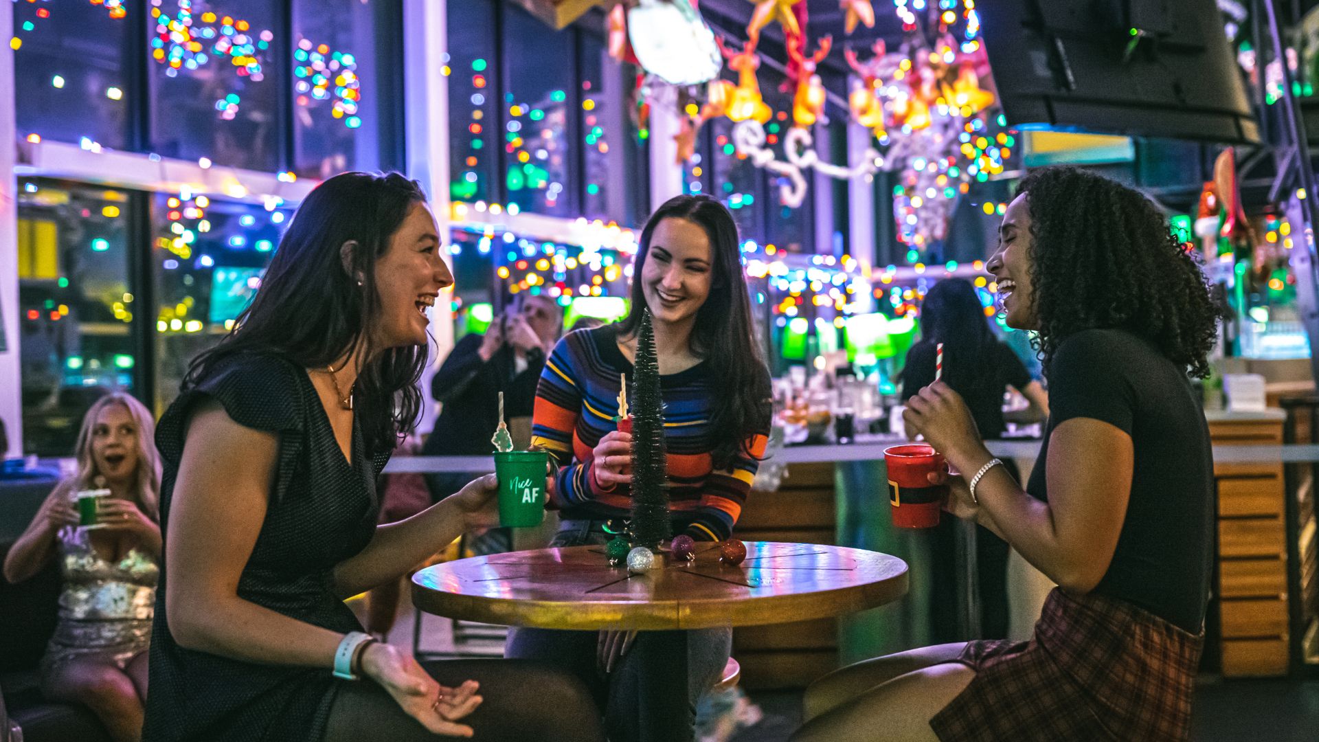 A group of girlfriends cheers at Up on The Rooftop, the holiday pop-up bar at Three Sixty in St. Louis.