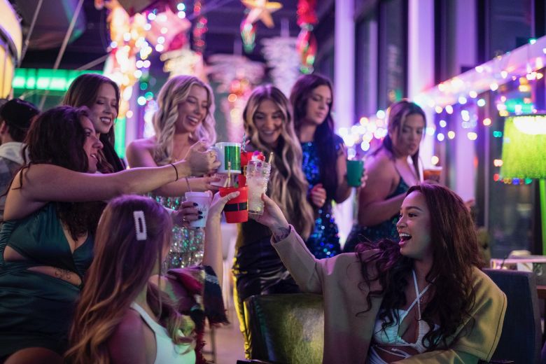 A group of girlfriends cheers at Up on The Rooftop, the holiday pop-up bar at Three Sixty in St. Louis.