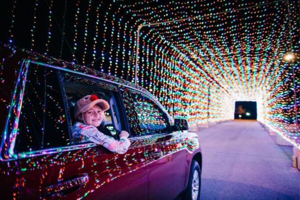 A little girl enjoys the tunnel of lights at WonderLight's Christmas at World Wide Technology Raceway.
