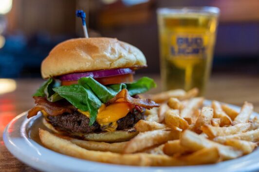 A juicy burger is paired with fries and a beer at Big Daddy's.