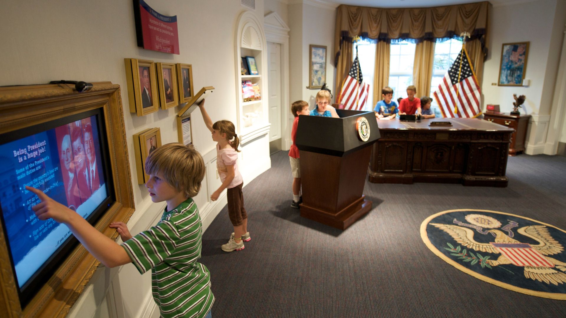Kids pretend to be president at The Magic House in St. Louis.