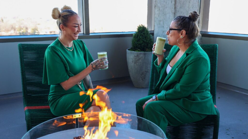 Two women enjoy cocktails by one of the firepits on the open-air terrace of 360 Westport.