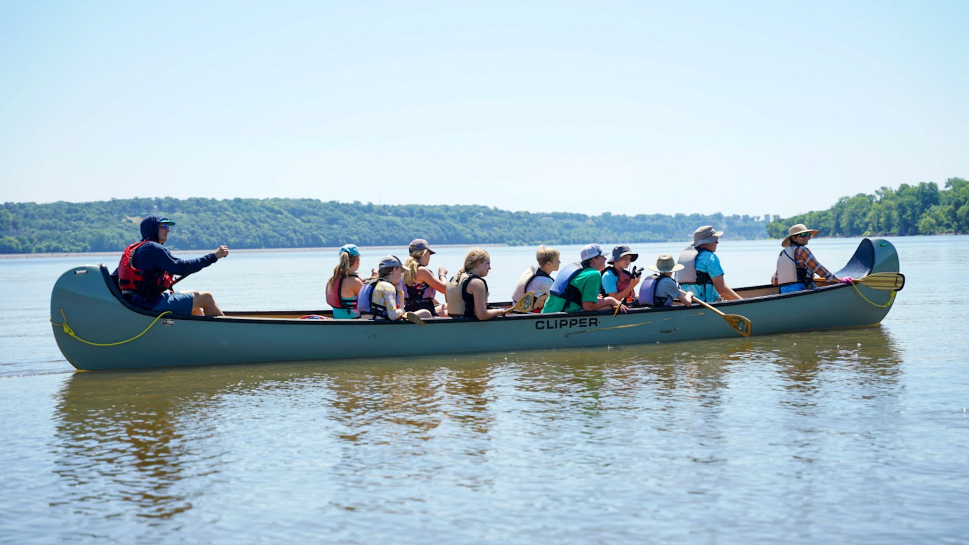 A group paddles a canoe down St. Louis' Great Rivers with Big Muddy Adventures.