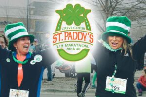 Two women cheer as they finish the Creve Coeur St. Paddy’s Half Marathon.