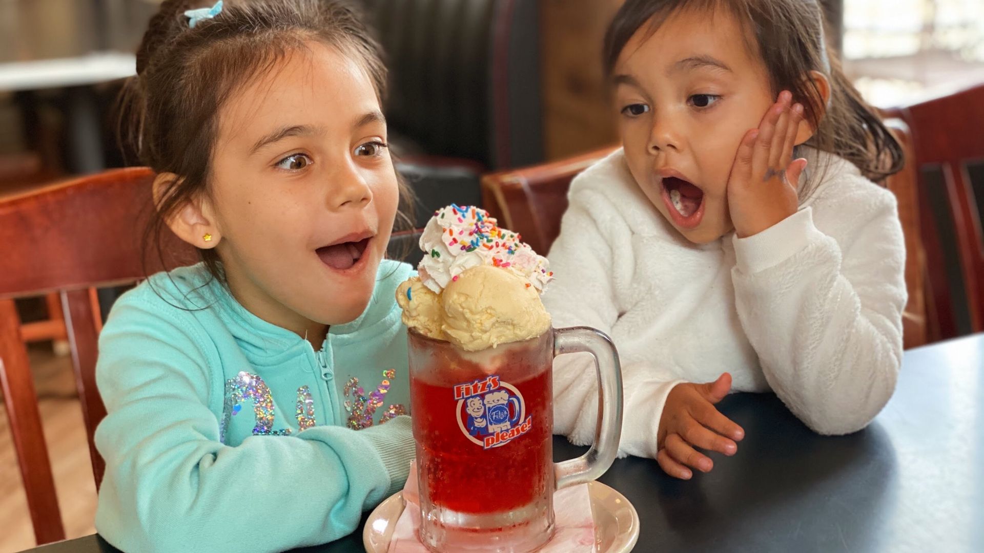 Two girls show their enthusiasm for an ice cream float from Fitz's, a kid-friendly restaurant in St. Louis.