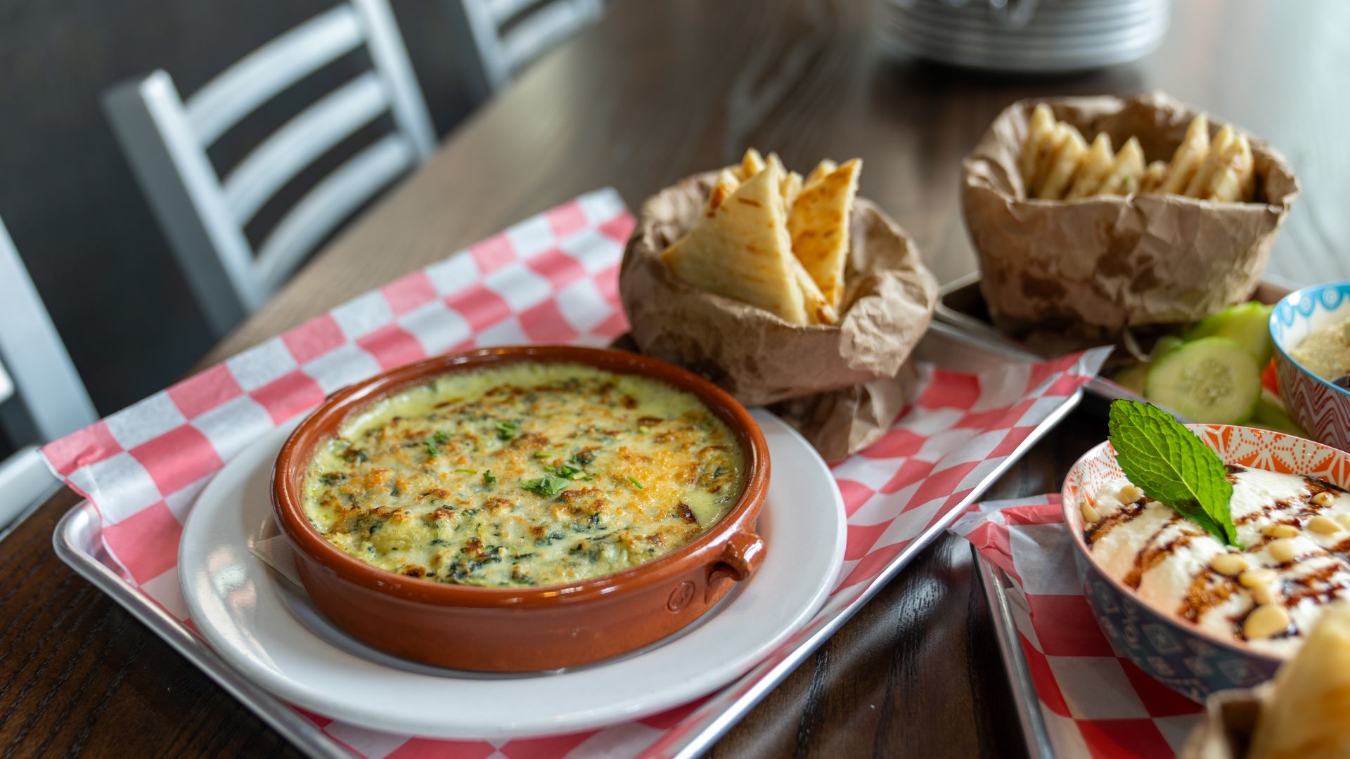 A gooey, cheesy dip is paired with pita.