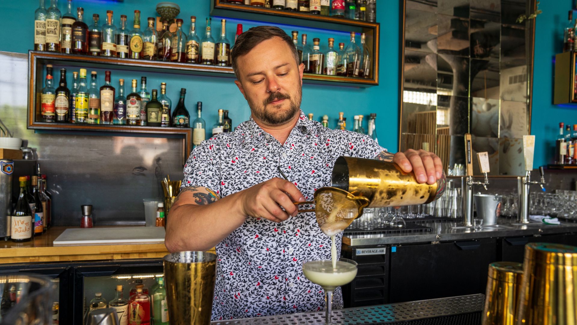 Beverage director Corey Moszer mixes drinks behind the bar of The Lucky Accomplice.