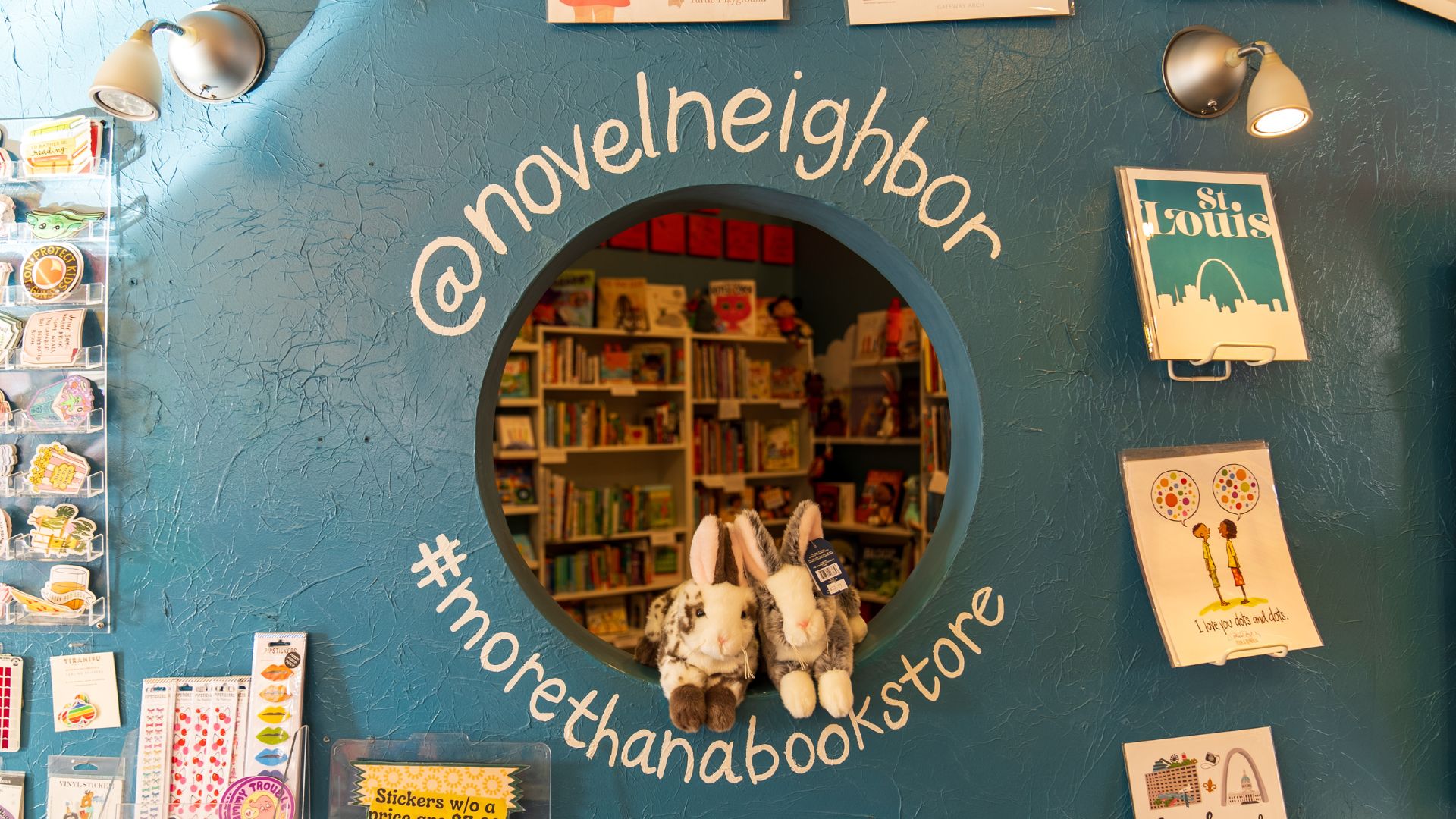 A window looks into a children's book section.