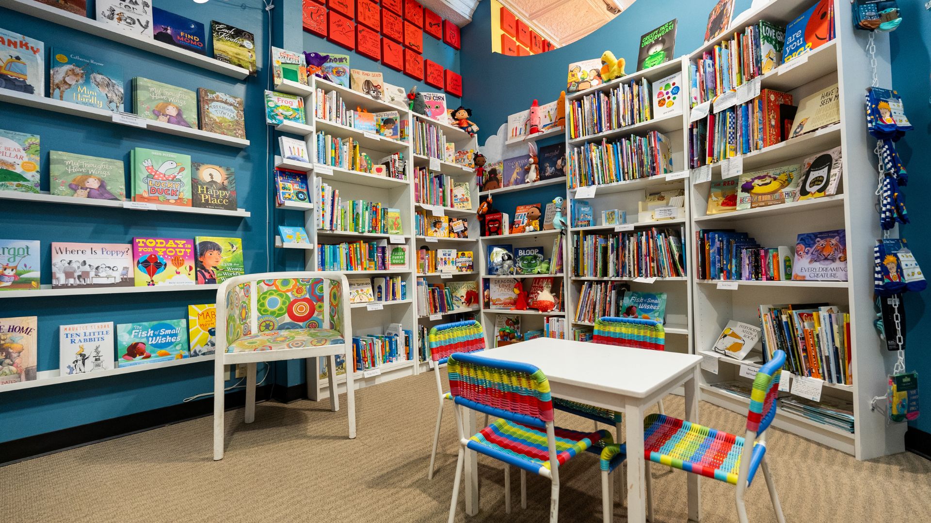The Novel Neighbor has a cozy corner with picture books and stuffed animals.