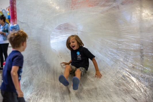 Kids enjoy a playscape made almost entirely of packing tape.
